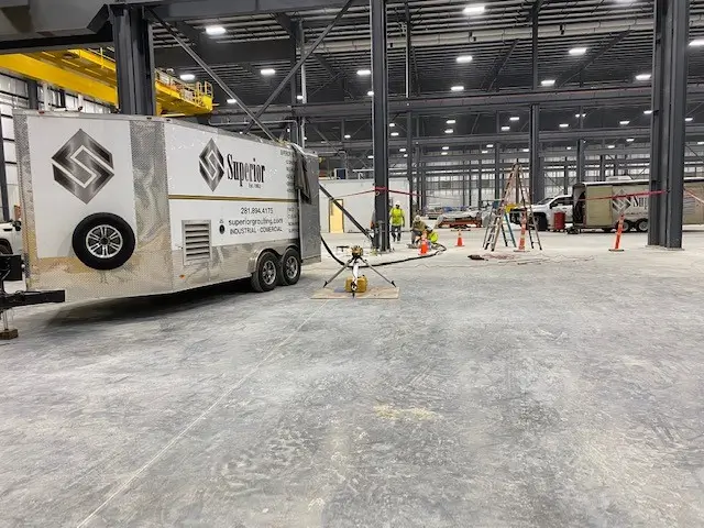 Industrial warehouse interior with Superior Polylift truck and equipment.