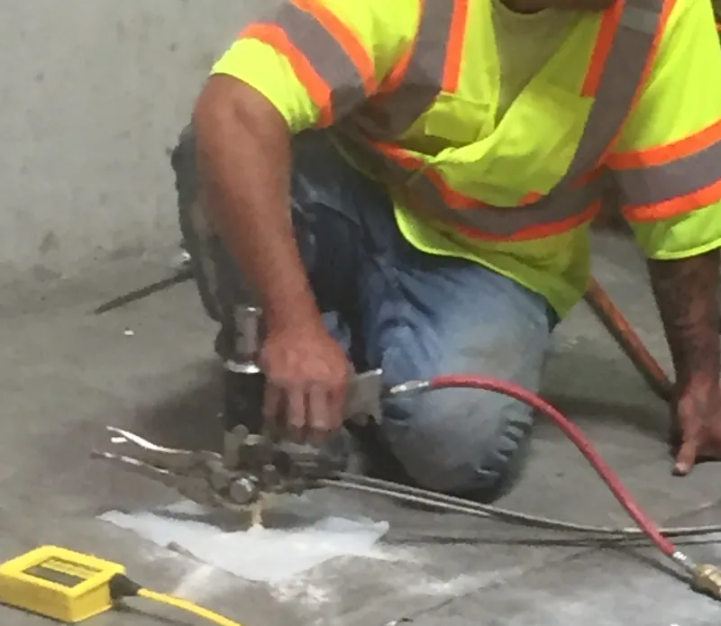 Worker on concrete floor.